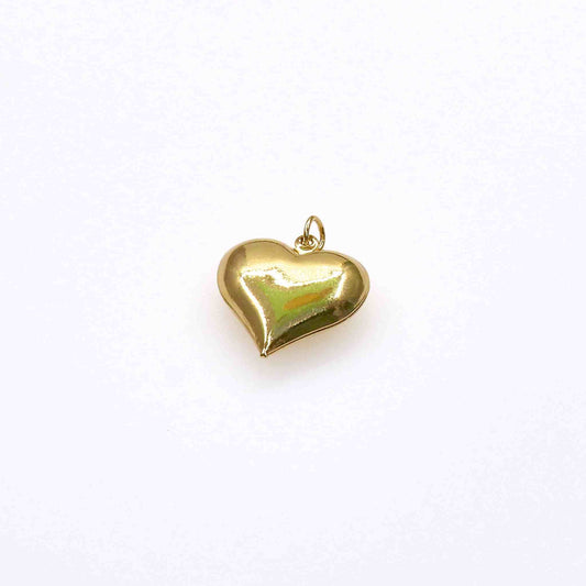 Chunky heart charm in gold finish against white background.